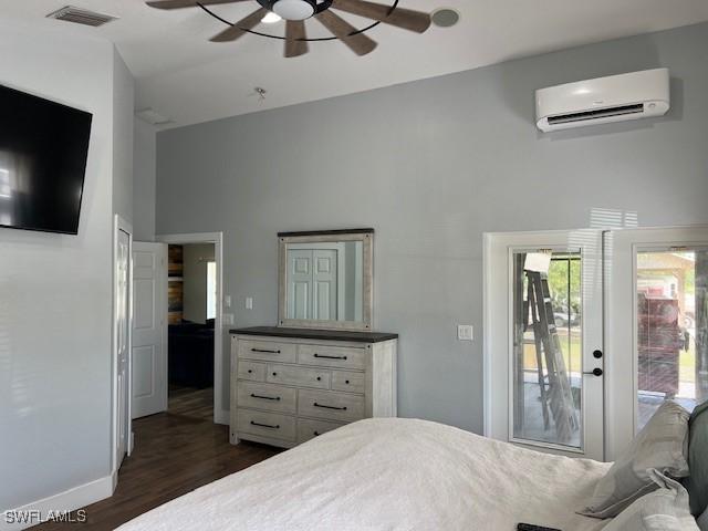 7834 15th Pl, Labelle, FL 33935 - bedroom featuring a high ceiling, a wall mounted air conditioner, baseboards, visible vents, and dark wood-style floors