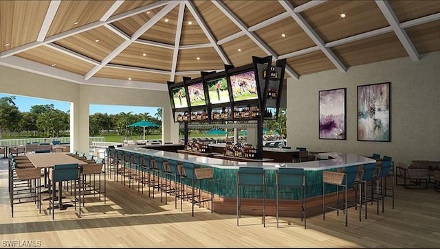 bar featuring beamed ceiling, indoor wet bar, and wood finished floors