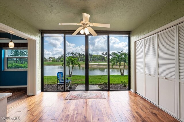 unfurnished sunroom with a water view