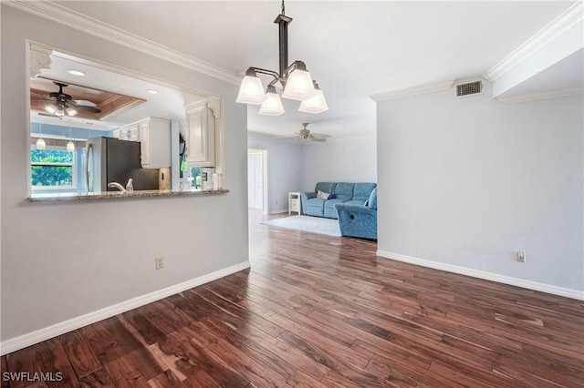 interior space featuring ornamental molding, visible vents, ceiling fan, and dark wood-type flooring