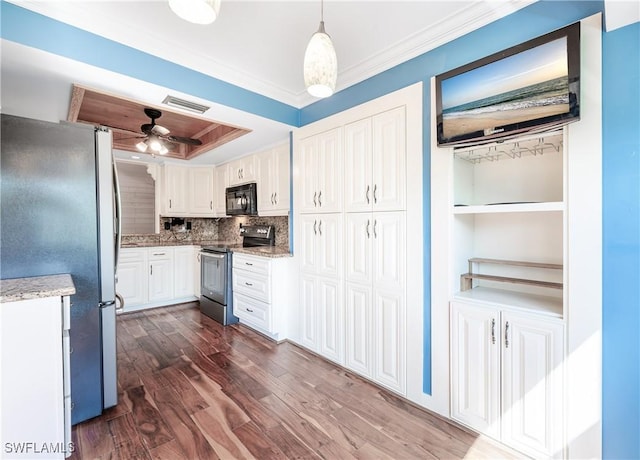 kitchen with stainless steel appliances, white cabinets, crown molding, visible vents, and dark wood-type flooring