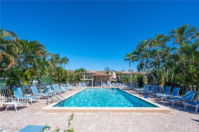 pool with fence and a patio