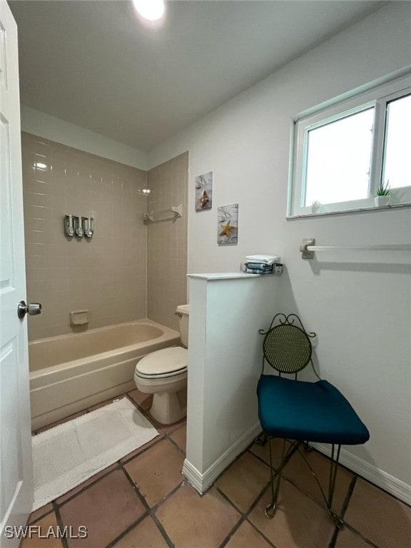 bathroom featuring shower / bathtub combination, tile patterned floors, and toilet