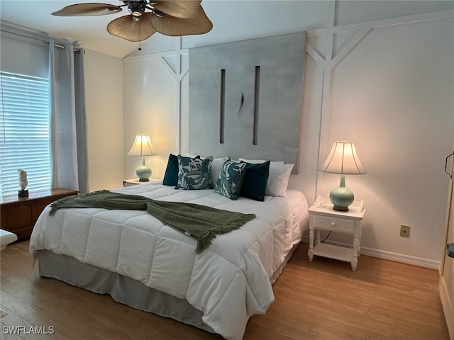 bedroom featuring a ceiling fan, baseboards, and light wood-style floors