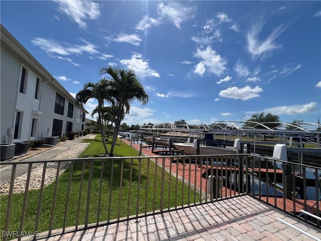 1016 SE 46th St Unit 102, Cape Coral, FL 33904 - balcony with a boat dock, boat lift, a water view, and central AC unit