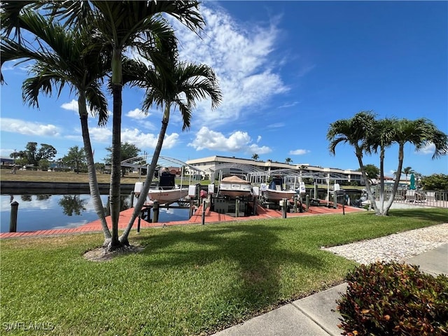 1016 SE 46th St Unit 102, Cape Coral, FL 33904 - dock area featuring boat lift, a water view, and a yard