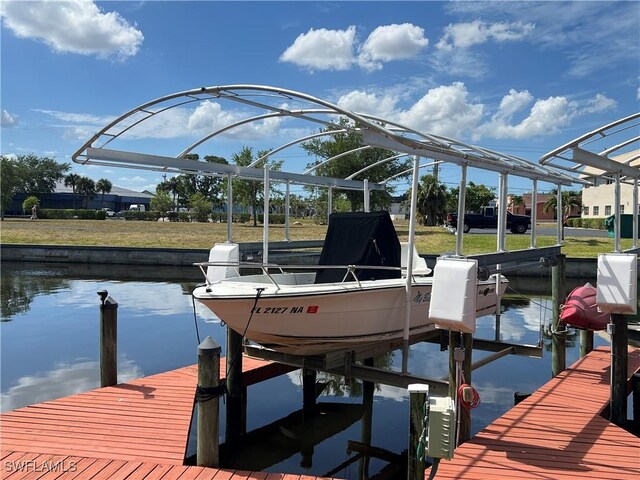 1016 SE 46th St Unit 102, Cape Coral, FL 33904 - view of dock featuring a water view and boat lift