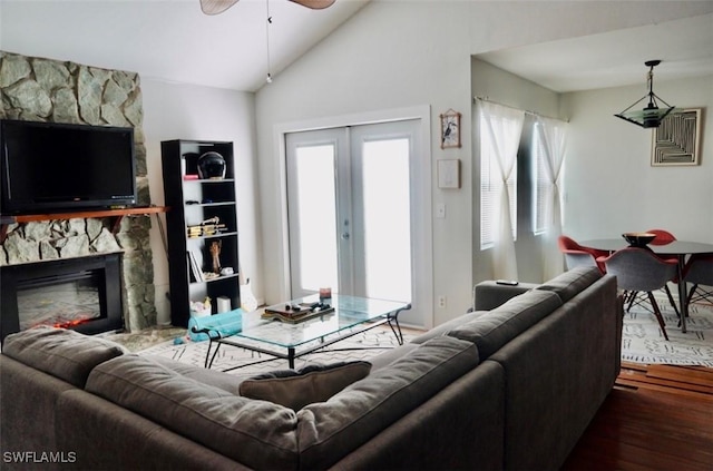 6053 Timberwood Cir Unit 233, Fort Myers, FL 33908 - living room featuring a healthy amount of sunlight, a stone fireplace, a ceiling fan, and wood finished floors