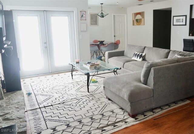 6053 Timberwood Cir Unit 233, Fort Myers, FL 33908 - living area with plenty of natural light, french doors, and wood finished floors