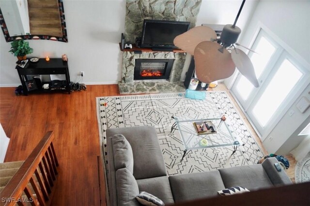 6053 Timberwood Cir Unit 233, Fort Myers, FL 33908 - living room featuring stairway, baseboards, a fireplace, and wood finished floors
