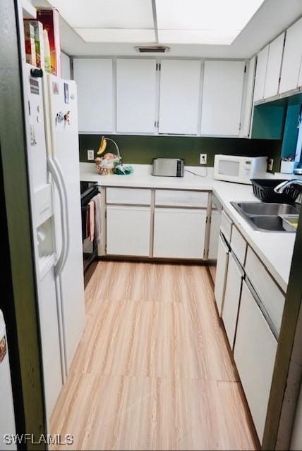 6053 Timberwood Cir Unit 233, Fort Myers, FL 33908 - kitchen featuring white appliances, white cabinetry, a sink, and light countertops