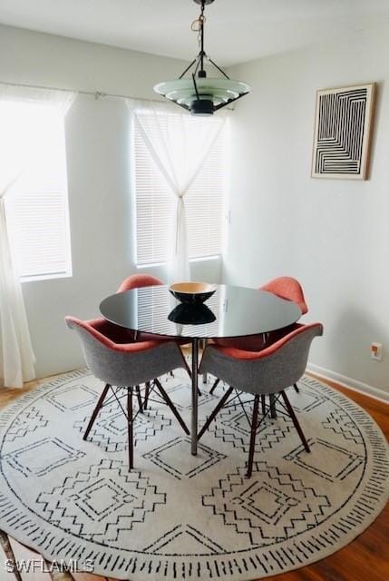 6053 Timberwood Cir Unit 233, Fort Myers, FL 33908 - dining space featuring a healthy amount of sunlight, baseboards, wood finished floors, and visible vents