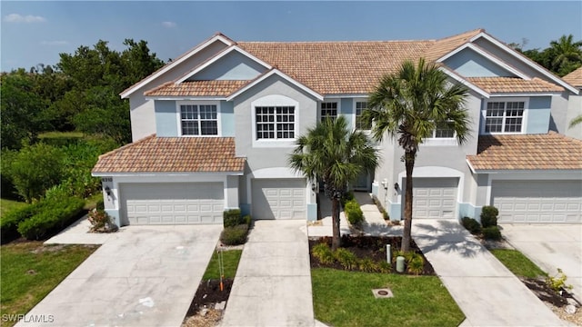 8310 Village Edge Cir Unit 3, Fort Myers, FL 33919 - view of front of house featuring an attached garage, stucco siding, and a tile roof