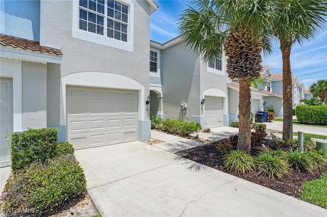 8310 Village Edge Cir Unit 3, Fort Myers, FL 33919 - view of front of house featuring a garage, stucco siding, driveway, and a tiled roof