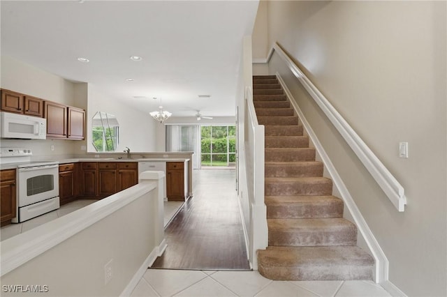8310 Village Edge Cir Unit 3, Fort Myers, FL 33919 - stairway featuring recessed lighting, baseboards, an inviting chandelier, and tile patterned floors