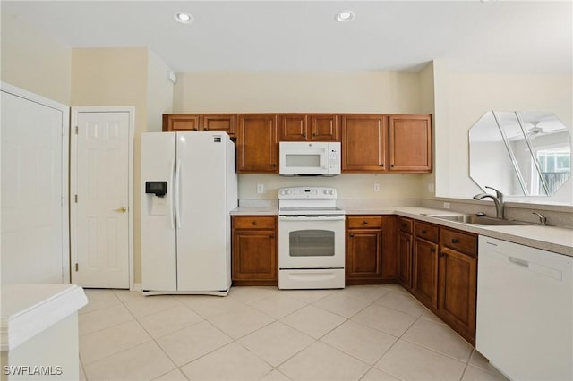 8310 Village Edge Cir Unit 3, Fort Myers, FL 33919 - kitchen featuring white appliances, brown cabinetry, a sink, and light countertops
