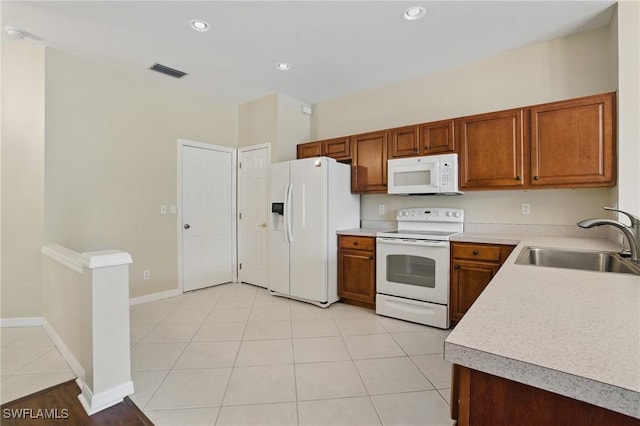 8310 Village Edge Cir Unit 3, Fort Myers, FL 33919 - kitchen featuring a sink, brown cabinets, white appliances, and light countertops
