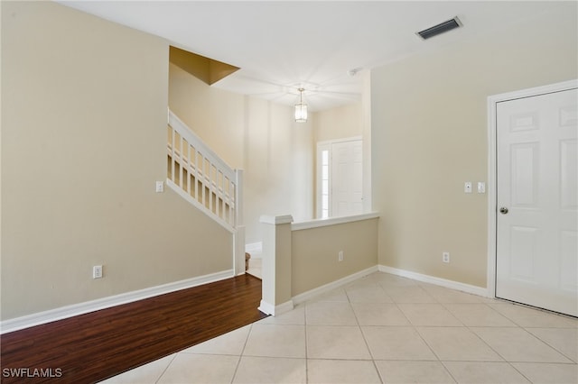 8310 Village Edge Cir Unit 3, Fort Myers, FL 33919 - unfurnished room with stairs, baseboards, visible vents, and light tile patterned floors