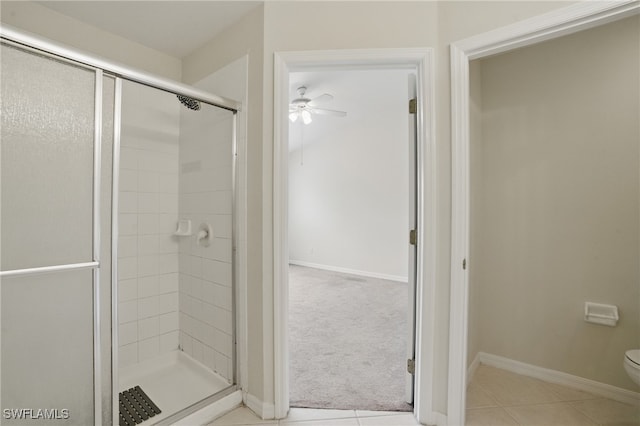 8310 Village Edge Cir Unit 3, Fort Myers, FL 33919 - bathroom featuring a ceiling fan, toilet, a shower stall, and tile patterned flooring