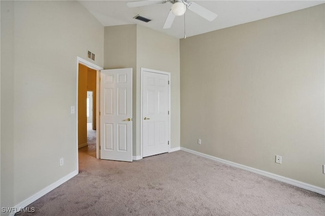 8310 Village Edge Cir Unit 3, Fort Myers, FL 33919 - unfurnished bedroom featuring visible vents, baseboards, carpet floors, and high vaulted ceiling