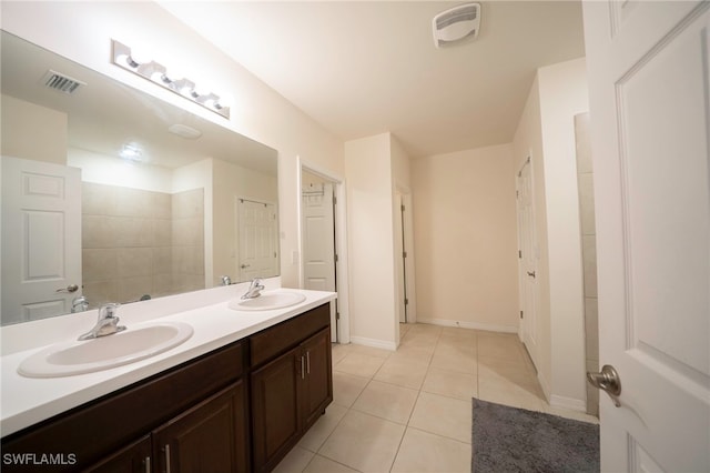 full bathroom featuring double vanity, tile patterned floors, visible vents, and a sink
