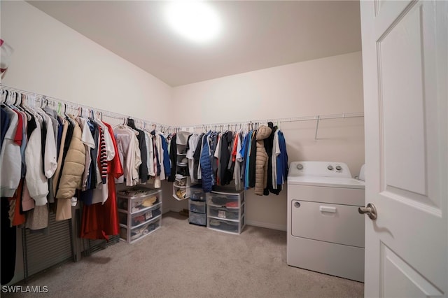 spacious closet with light colored carpet and washer / clothes dryer