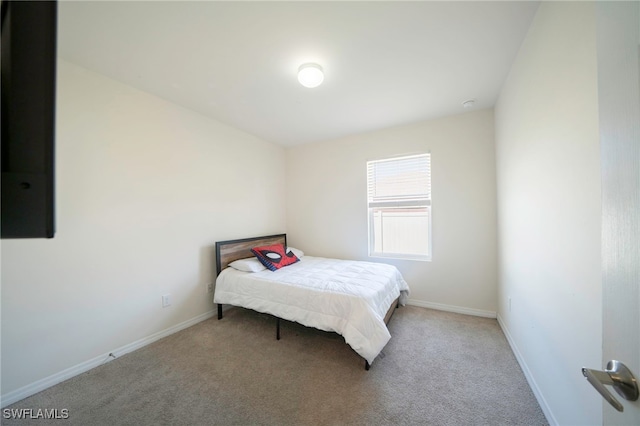 carpeted bedroom with baseboards