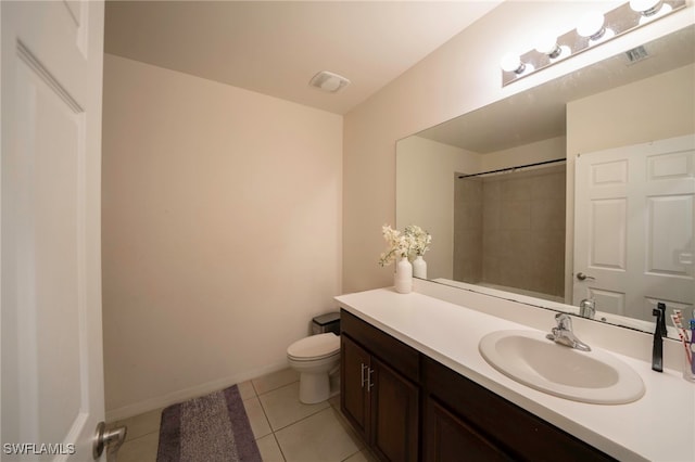 bathroom featuring tile patterned flooring, vanity, toilet, baseboards, and visible vents