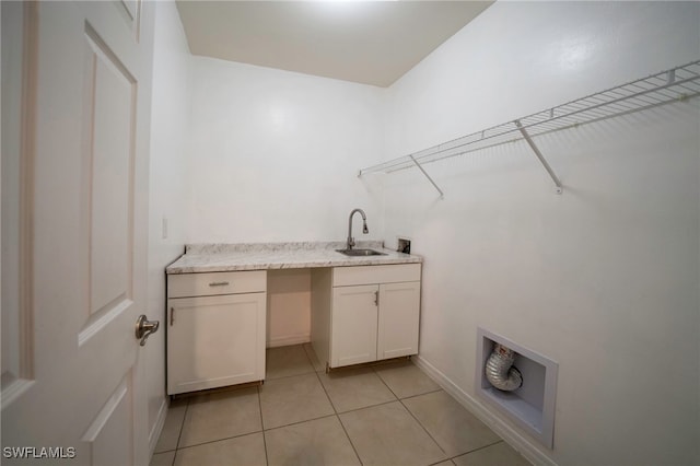 clothes washing area with cabinet space, washer hookup, a sink, indoor wet bar, and light tile patterned floors