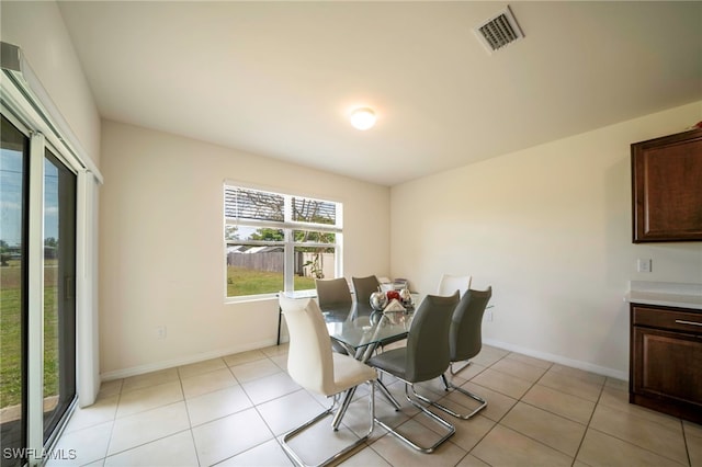 dining area with baseboards, visible vents, and light tile patterned floors