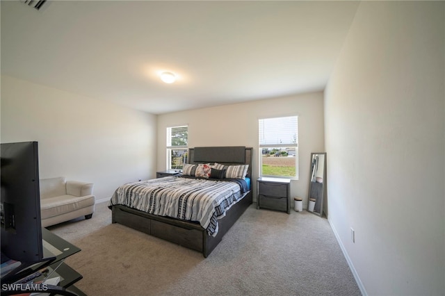 carpeted bedroom with baseboards and visible vents