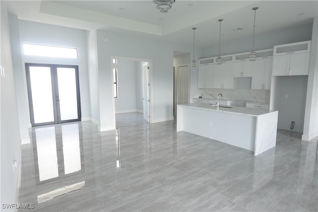 224 Preston St, Lehigh Acres, FL 33974 - kitchen featuring a sink, white cabinets, a kitchen island with sink, french doors, and light countertops
