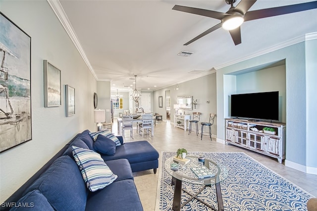 living area with crown molding, baseboards, ceiling fan with notable chandelier, and visible vents