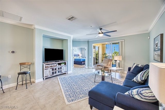 tiled living room featuring visible vents, a ceiling fan, baseboards, and crown molding