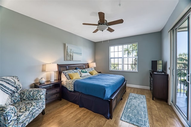 bedroom with access to outside, baseboards, a ceiling fan, and wood finished floors