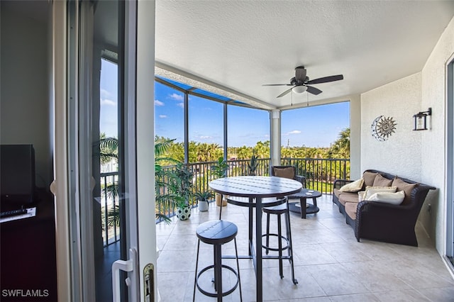 sunroom with an outdoor hangout area and a ceiling fan