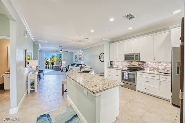 kitchen with visible vents, a sink, appliances with stainless steel finishes, and ornamental molding