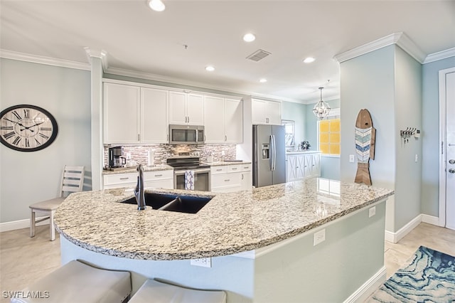 kitchen with baseboards, a sink, white cabinets, and stainless steel appliances