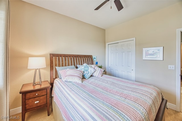 bedroom with a ceiling fan, baseboards, and a closet