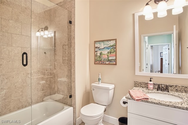 full bathroom featuring vanity, baseboards, toilet, and shower / bath combination with glass door