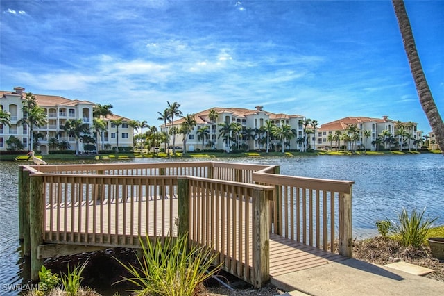 dock area with a residential view and a deck with water view