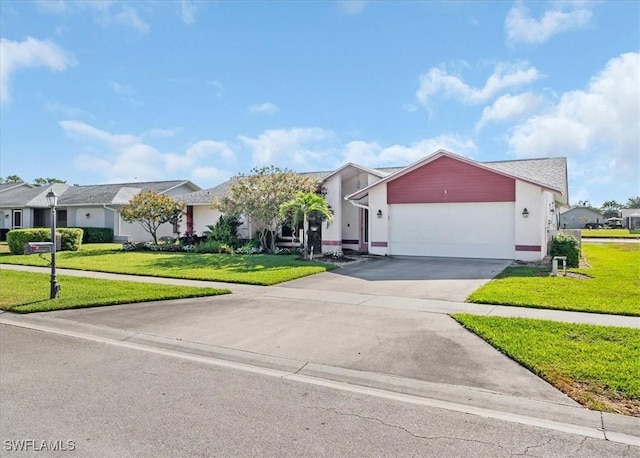 view of front of home featuring an attached garage, a front lawn, a residential view, and concrete driveway