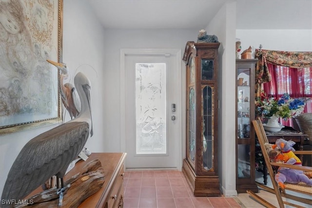 tiled foyer featuring baseboards