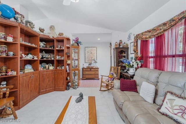 living area featuring light tile patterned flooring and vaulted ceiling