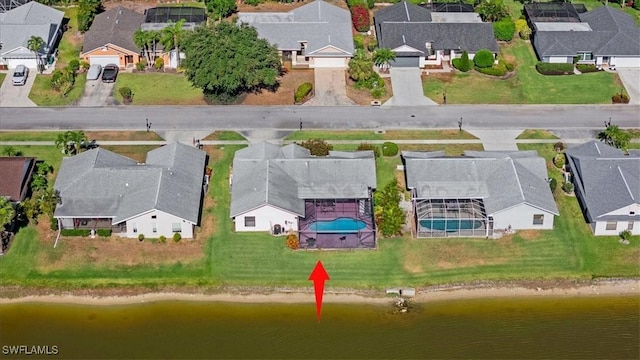 bird's eye view featuring a residential view and a water view