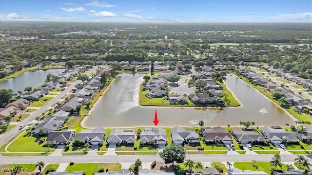 bird's eye view featuring a water view and a residential view
