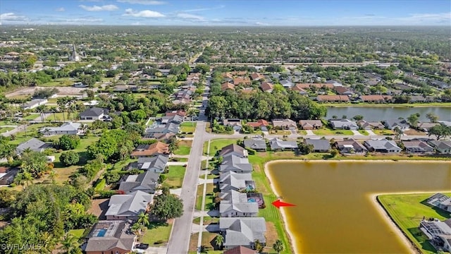 drone / aerial view with a water view and a residential view