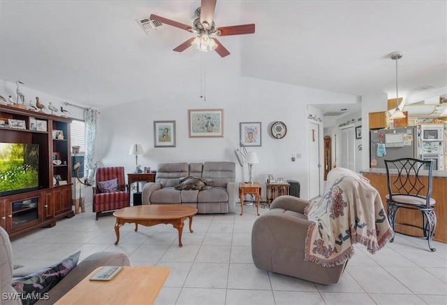 living area with visible vents, a ceiling fan, lofted ceiling, and light tile patterned flooring