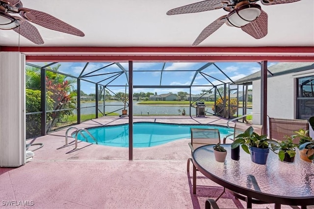 pool featuring a ceiling fan, a patio area, a lanai, and a water view