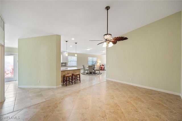 living room with baseboards, a ceiling fan, light tile patterned flooring, and recessed lighting